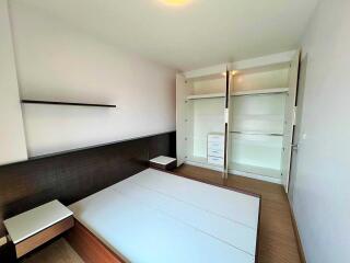 Unfurnished bedroom with open closets and blank walls