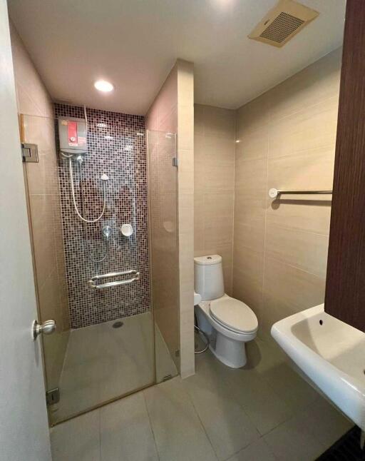 Modern bathroom with shower, toilet, and sink