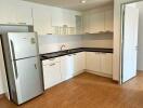 Modern kitchen with white cabinets and stainless steel appliances