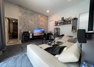 Modern living room with large TV and comfortable seating
