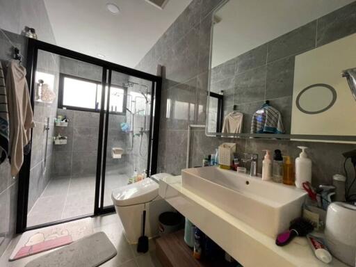 Modern bathroom with large mirror and glass shower enclosure