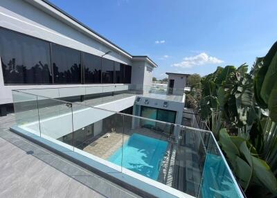 Modern house with glass railings and a pool