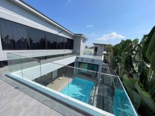Modern house with glass railings and a pool