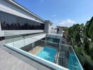 Modern house with glass railings and a pool