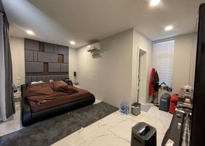 Modern bedroom with bed, air conditioner, and storage space