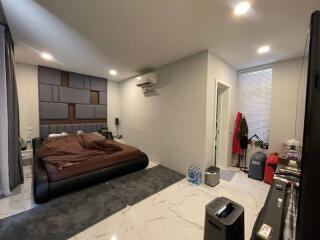 Modern bedroom with bed, air conditioner, and storage space