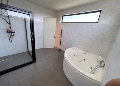 Bathroom with a shower stall and a jacuzzi tub