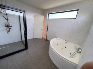 Bathroom with a shower stall and a jacuzzi tub