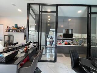 Modern kitchen with glass partition and dining area
