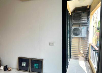 Small balcony area with air conditioning units and a view outside