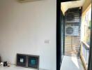 Small balcony area with air conditioning units and a view outside