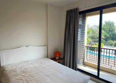 Bright bedroom with a large window and balcony access