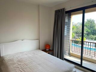 Bright bedroom with a large window and balcony access