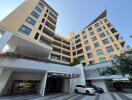 Modern apartment building exterior with parking area