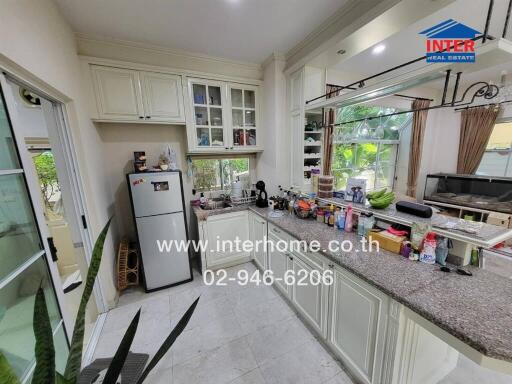 Modern kitchen with white cabinetry and appliances