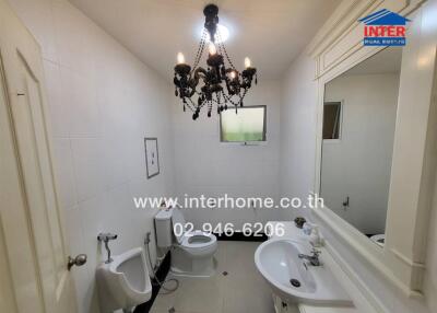 Modern bathroom with chandelier and sanitary fixtures