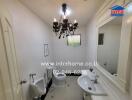 Modern bathroom with chandelier and sanitary fixtures