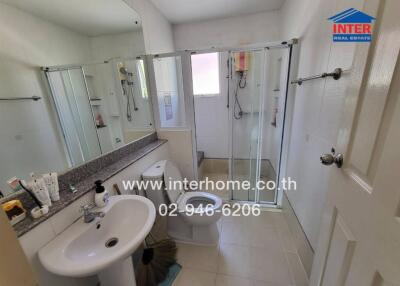 Bathroom with sink, mirror, shower area and toilet