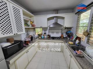 Modern kitchen with white cabinets and stainless steel appliances