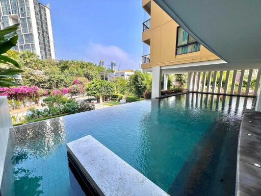 Outdoor pool area with a view of surrounding buildings