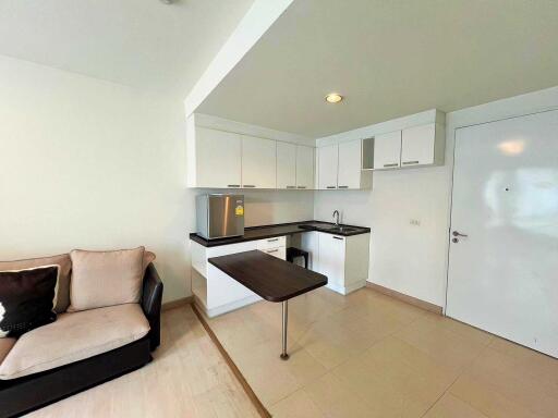 Modern kitchen area with appliances and a small dining bar