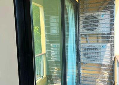 Balcony with glass door and air conditioning units