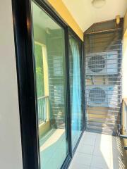 Balcony with glass door and air conditioning units