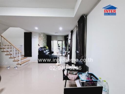 Modern living room with staircase and natural light