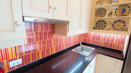 Modern kitchen with colorful backsplash and decorative shelves