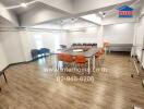 Spacious meeting room with wooden flooring and modern lighting.