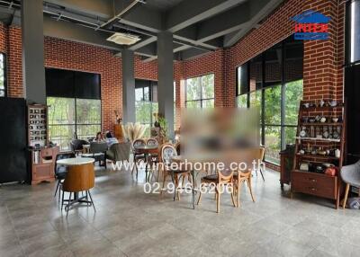 Spacious open area with large windows, seating arrangements, and modern decor