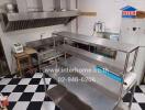 Commercial kitchen with stainless steel appliances and checkered floor