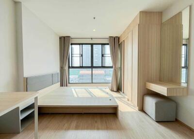 Modern bedroom with large window and built-in furniture