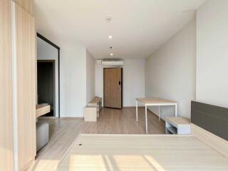 Modern living area with minimalist furniture and wooden flooring