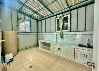 Well-lit utility room with storage and washing area