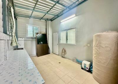 Spacious utility room with a large water tank and ample storage space