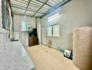 Spacious utility room with a large water tank and ample storage space