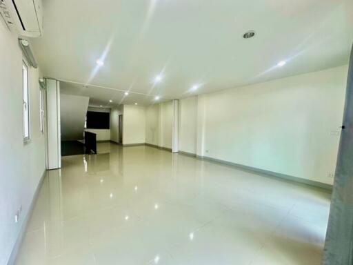 Spacious main living area with large windows and recessed lighting