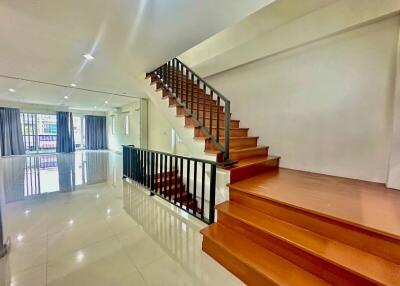 Staircase leading to the upper floor with spacious living area