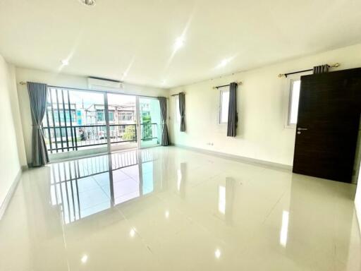 Spacious bright living room with large windows and tiled floor