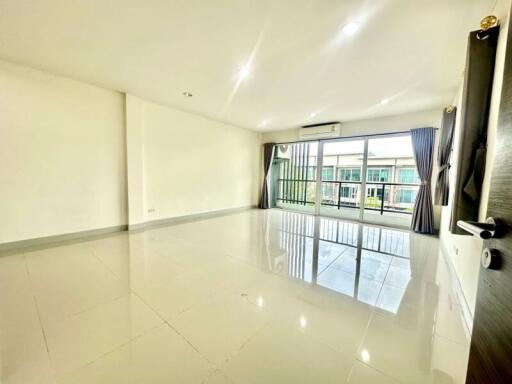 Spacious living room with large windows and balcony access