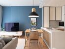 Modern living room and kitchen with blue accent wall and stylish furniture