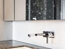 Modern bathroom sink with marble countertop and wall-mounted faucet