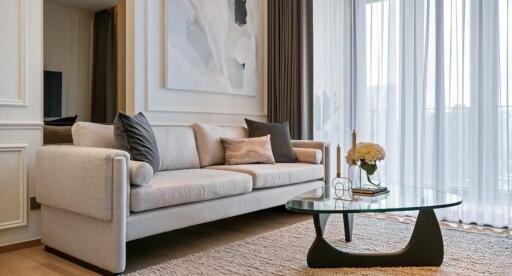 Modern living room with a large sofa, glass coffee table, and floor-to-ceiling windows with curtains.