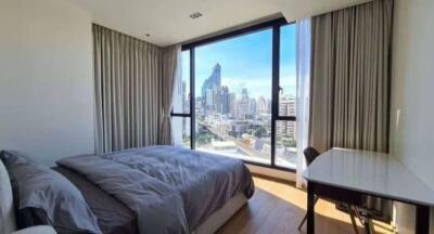 Bedroom with large window and city view