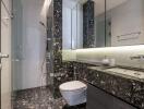 Modern bathroom with glass shower and black marble