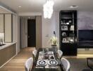 Modern dining area with table set for meal, and living room in the background