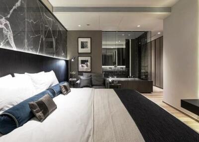 Modern bedroom with large bed, stylish decor, and modern lighting