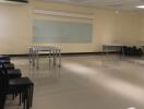 Spacious multipurpose room with modern lighting and whiteboard