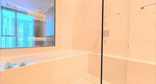 Modern bathroom with bathtub and glass shower enclosure